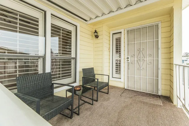 a view of a livingroom with furniture and a window