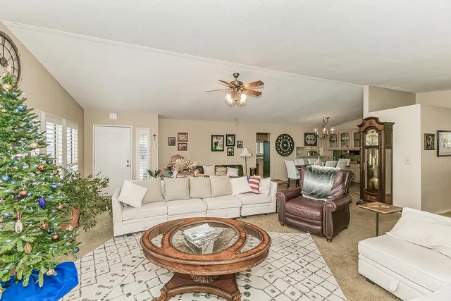 a living room with furniture and a chandelier