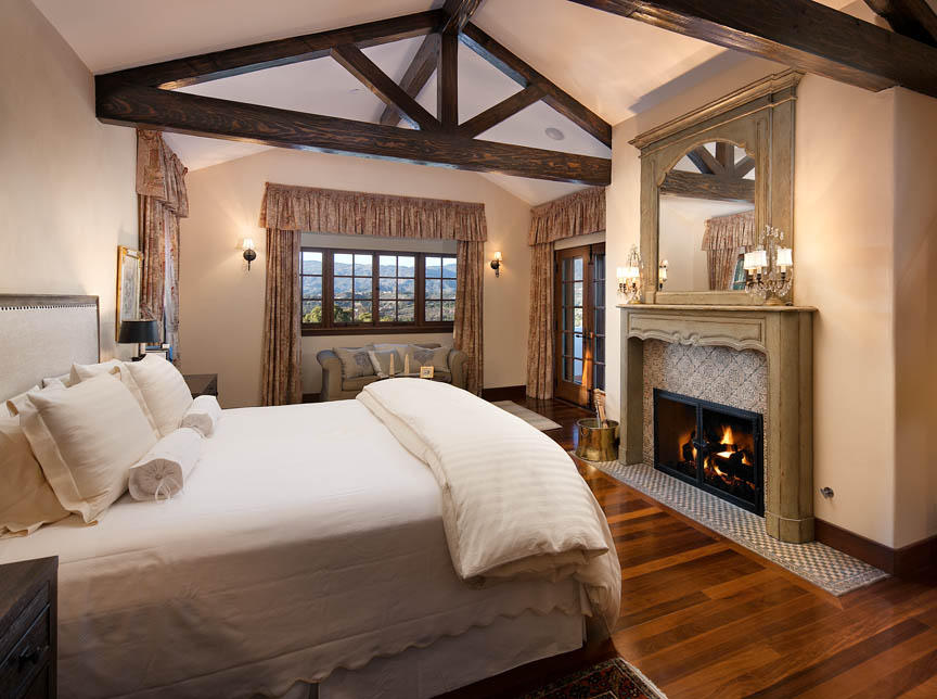 695 Via Hierba Santa Barbara, CA 93110 - Photo 13 of 29 a bed sitting in a bedroom and a fireplace next to a window
