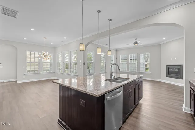 a kitchen with center island wooden floor and appliances
