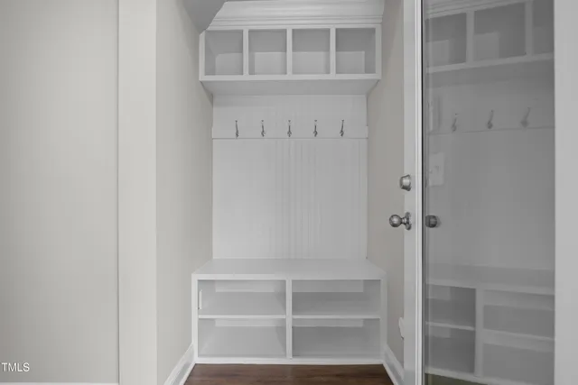 a view of walk in closet with empty racks