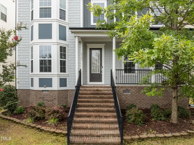 a front view of a house with a garden