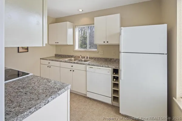 a kitchen with a sink stove and refrigerator