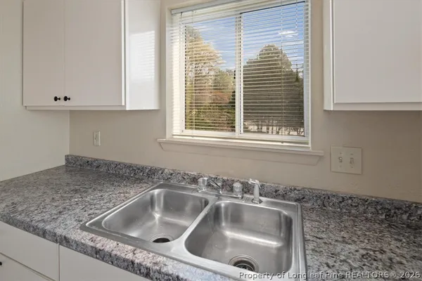 a kitchen with stainless steel appliances granite countertop a sink stove and cabinets