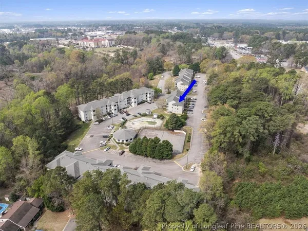 an aerial view of a house with outdoor seating