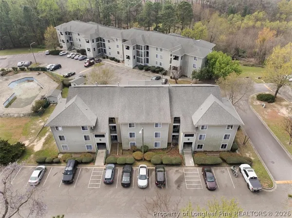 an aerial view of a house with outdoor seating