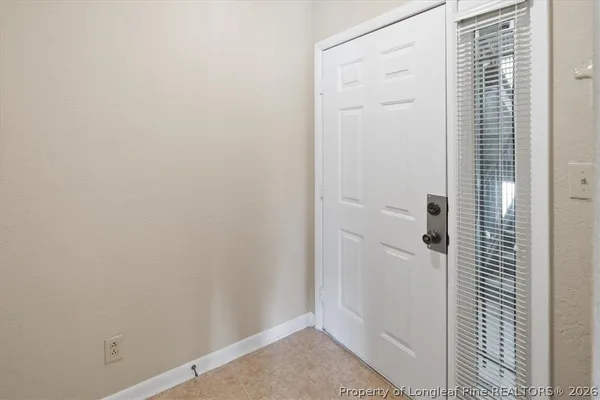 a view of an empty room with a fireplace