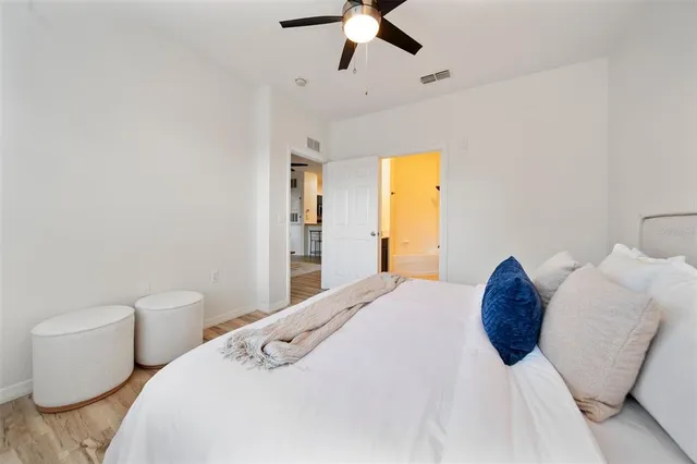 a bedroom with a bed and a chandelier