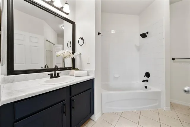 a bathroom with a bath tub sink and mirror