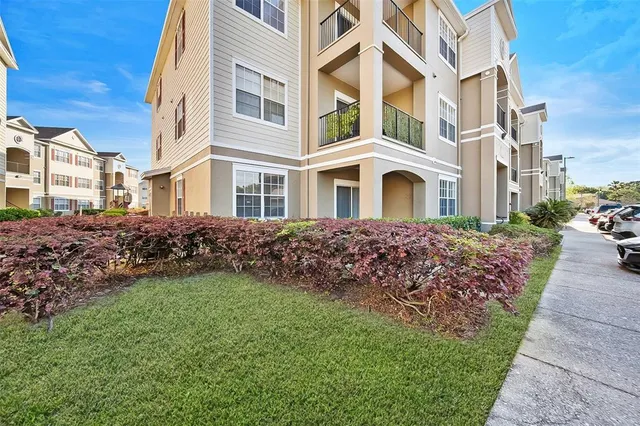 a front view of a residential apartment building with a yard