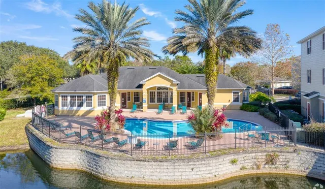 a view of a house with swimming pool and sitting area