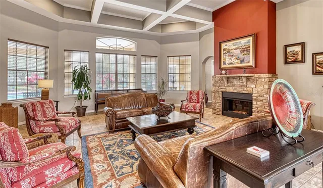 a living room with furniture a large window and a fireplace