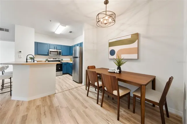 a view of a dining room with furniture a chandelier and wooden floor