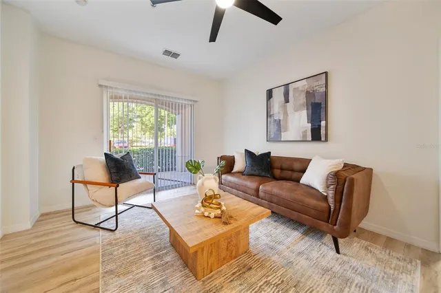 a living room with furniture and a wooden floor