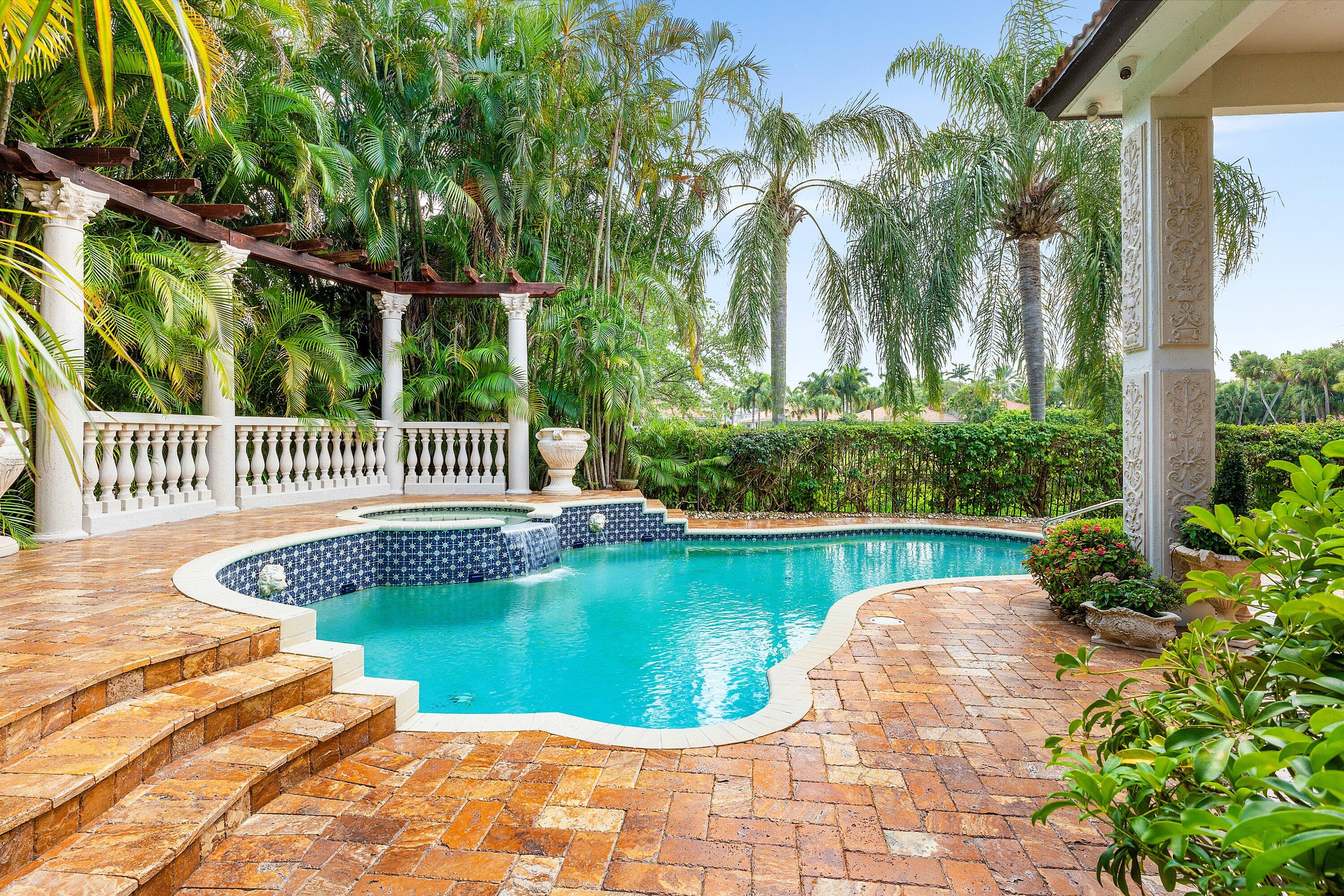 16312 Braeburn Ridge Trail Delray Beach, FL 33446 - Photo 2 of 12 a view of a swimming pool with a patio