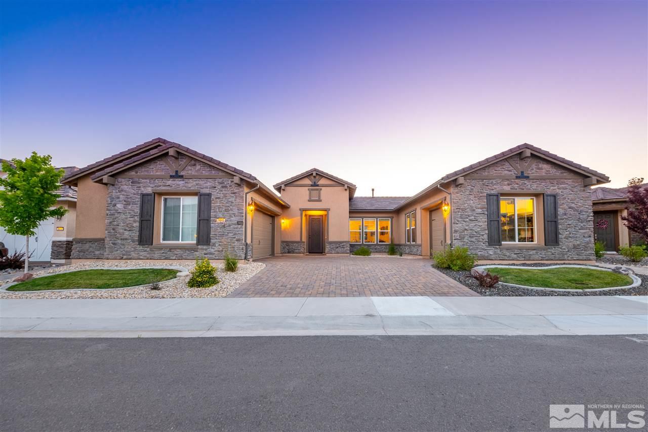 9845 Shadowless Trail Reno, NV 89521 - Photo 1 of 40 a front view of a house with a yard and trees