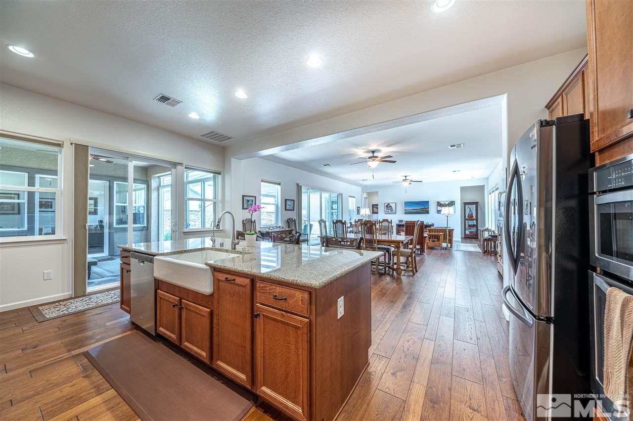 9845 Shadowless Trail Reno, NV 89521 - Photo 12 of 40 a kitchen with lots of counter top space and painting on the wall