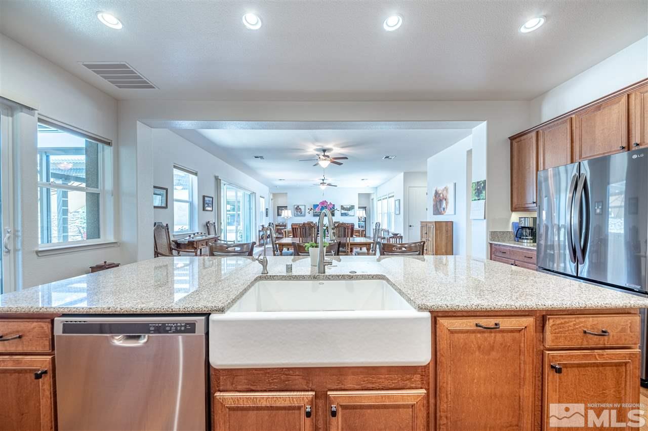 9845 Shadowless Trail Reno, NV 89521 - Photo 13 of 40 a kitchen with sink refrigerator and dining table