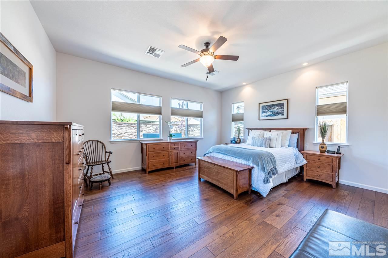 9845 Shadowless Trail Reno, NV 89521 - Photo 15 of 40 a bedroom with a bed wooden floor and window