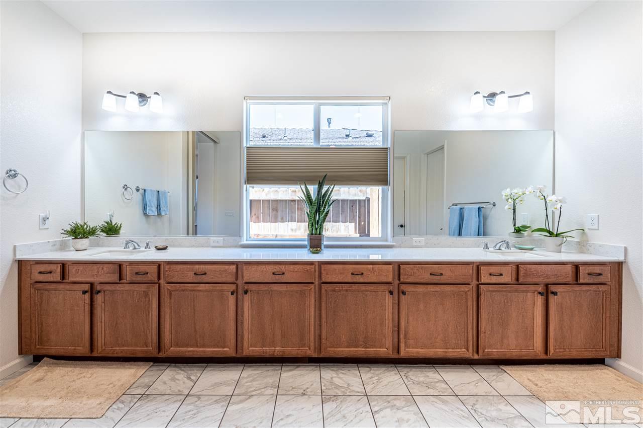 9845 Shadowless Trail Reno, NV 89521 - Photo 18 of 40 a spacious bathroom with a granite countertop sink and a mirror