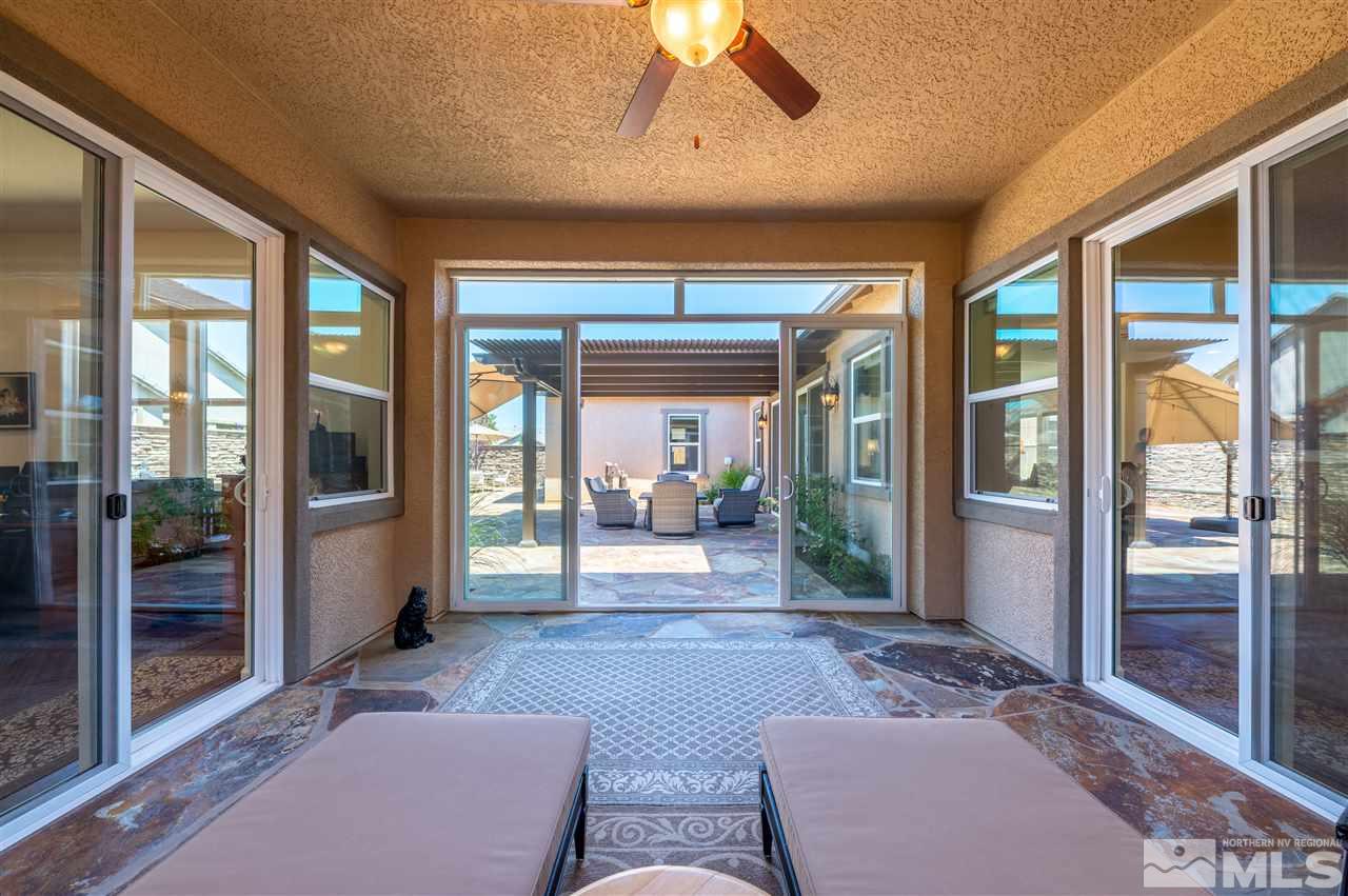 9845 Shadowless Trail Reno, NV 89521 - Photo 22 of 40 a living room with furniture and large windows