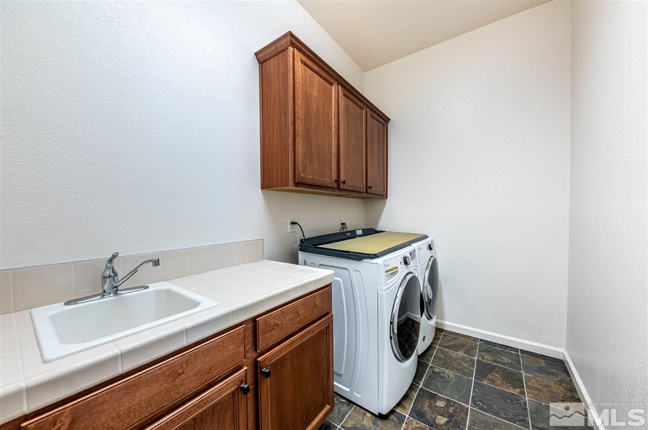 9845 Shadowless Trail Reno, NV 89521 - Photo 31 of 40 a utility room with dryer and washer