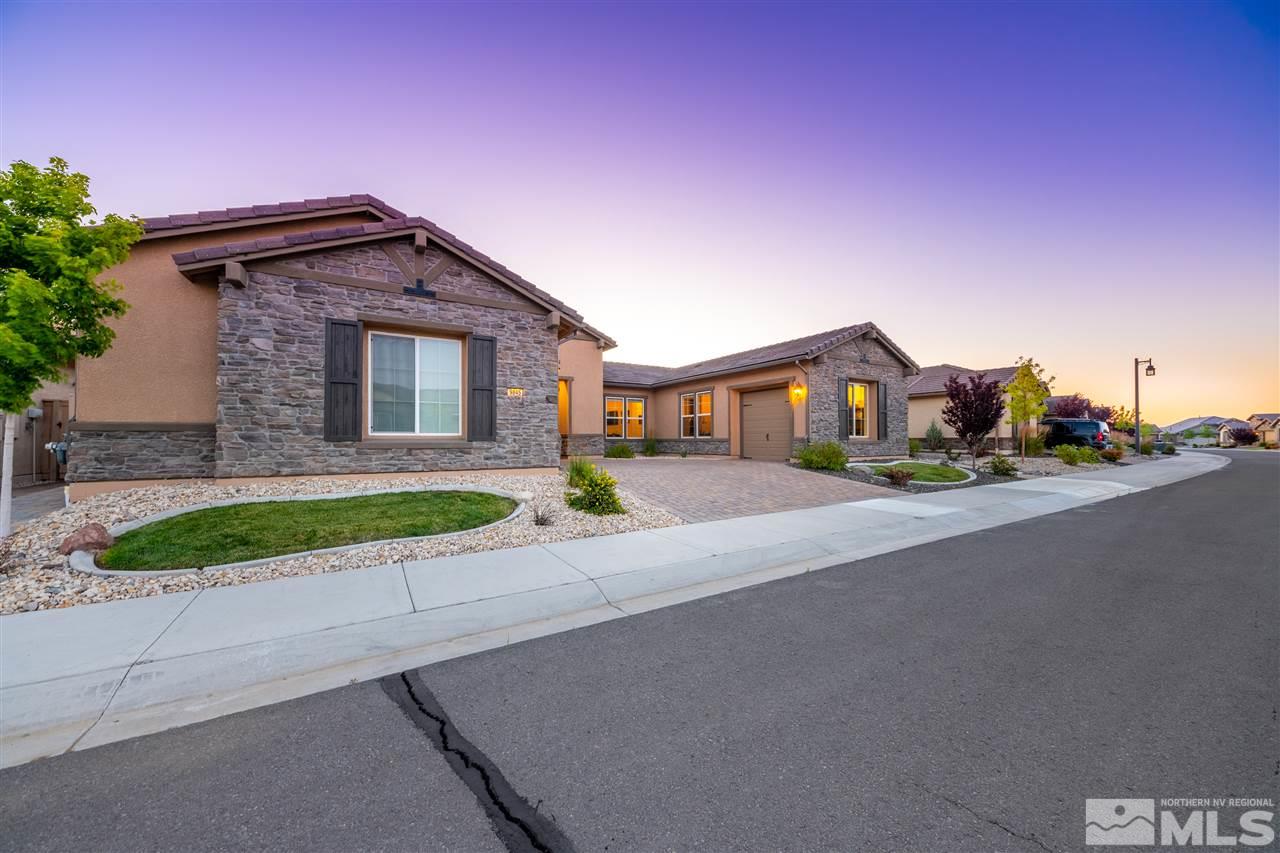 9845 Shadowless Trail Reno, NV 89521 - Photo 4 of 40 a front view of a house with a yard and garage