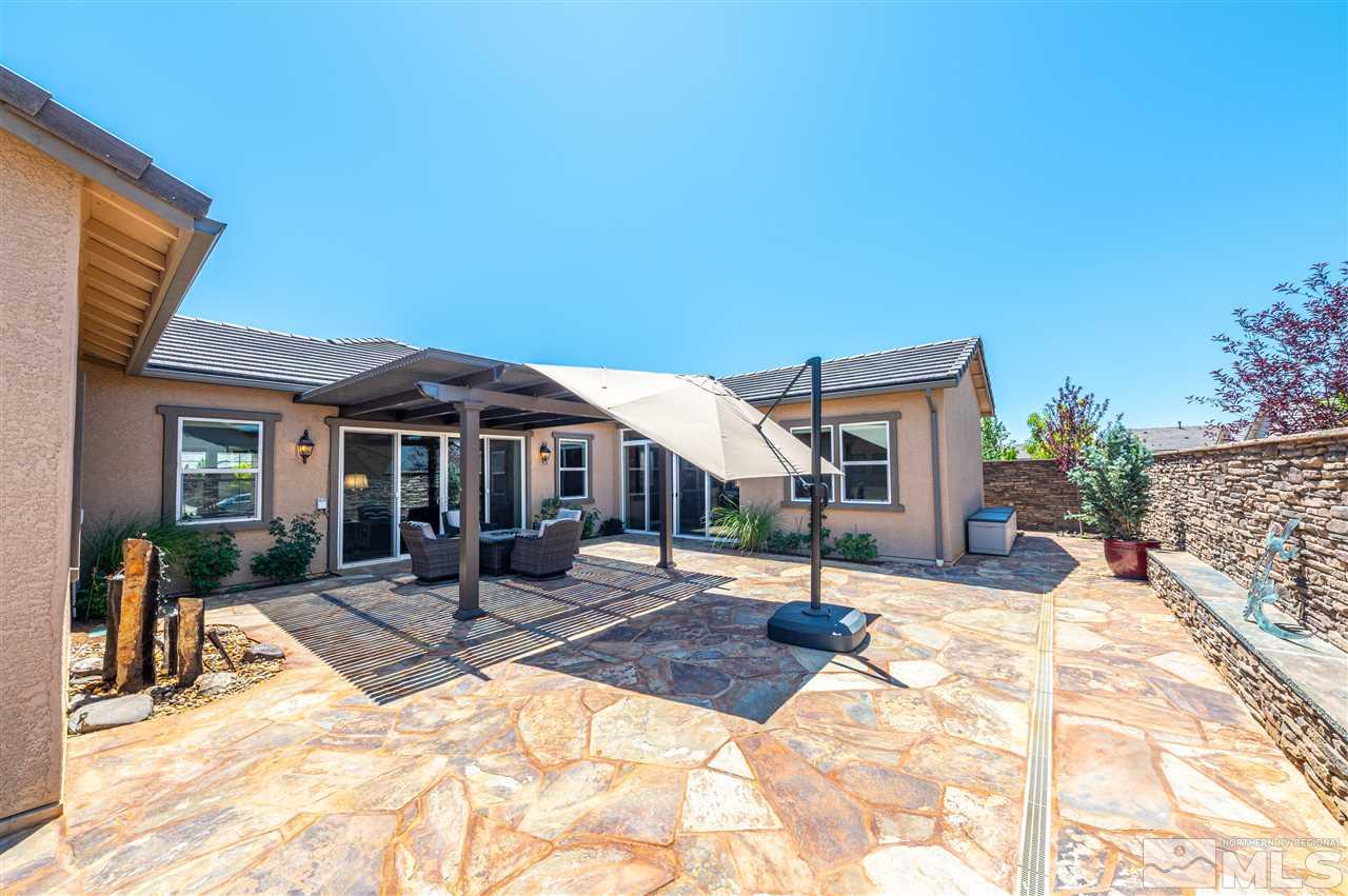 9845 Shadowless Trail Reno, NV 89521 - Photo 6 of 40 a patio with a table and chairs and potted plants