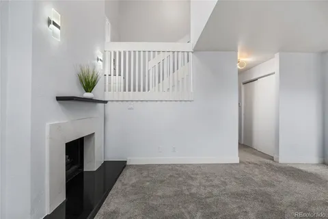 a bedroom with a bed and a flat tv screen on dresser