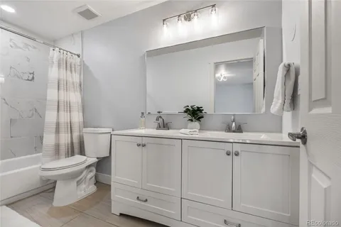 a bathroom with a sink toilet vanity and shower