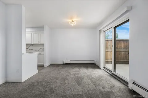 an empty room with a kitchen