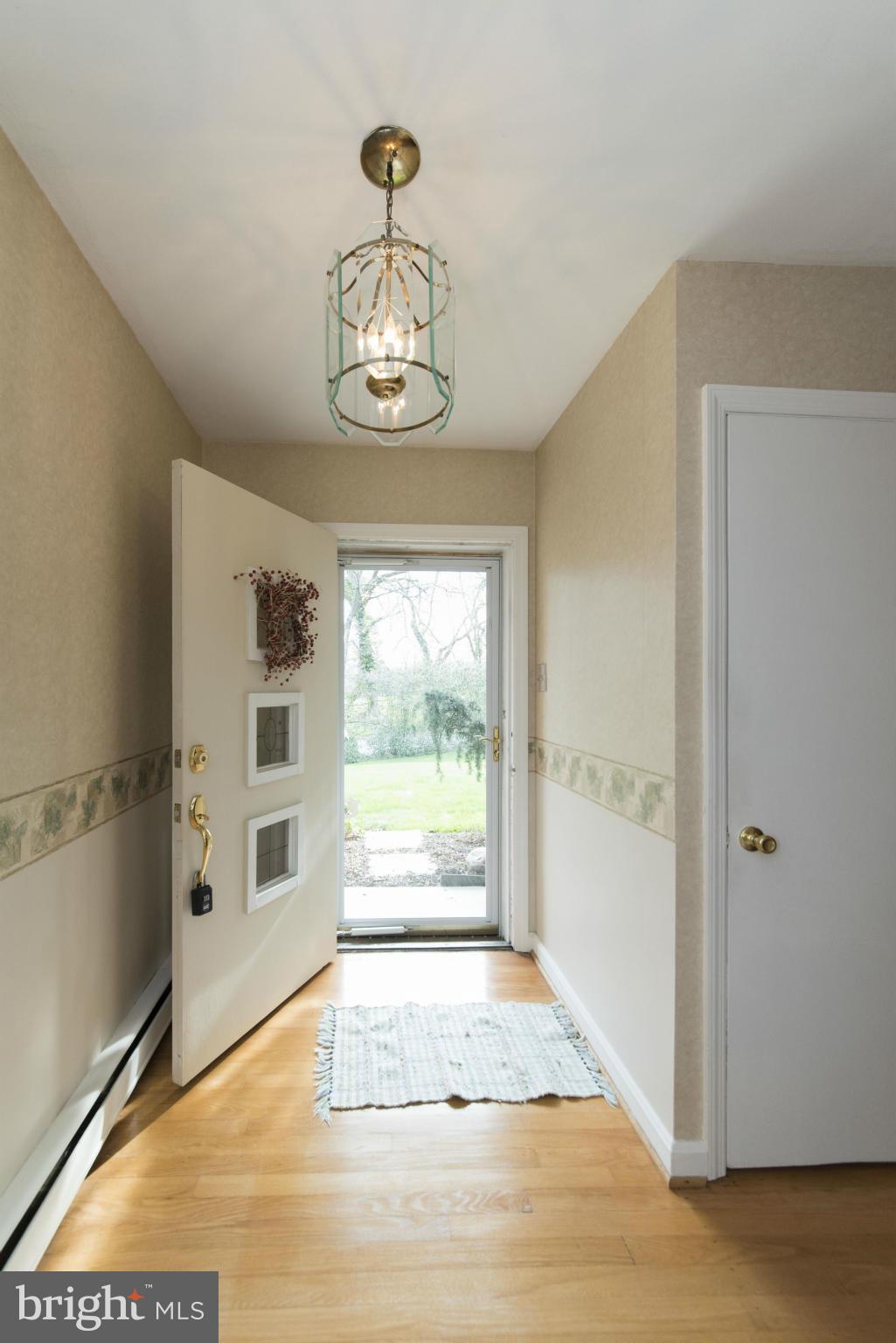 1107 Litchfield Road Baltimore, MD 21239 - Photo 2 of 30 a view of a livingroom with wooden floor and window