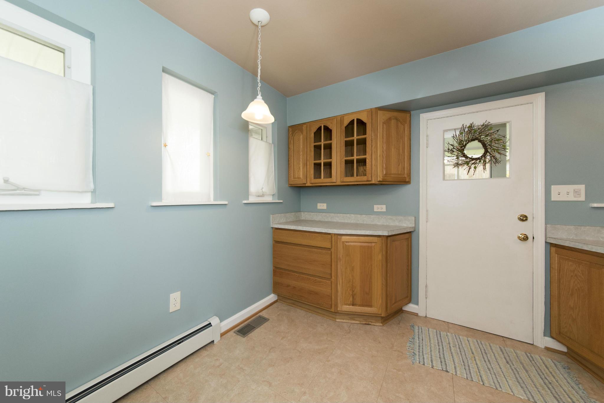 1107 Litchfield Road Baltimore, MD 21239 - Photo 11 of 30 a view of an empty room with window and wooden floor