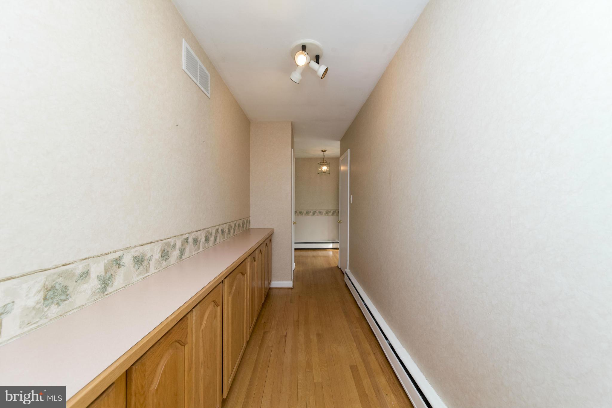 1107 Litchfield Road Baltimore, MD 21239 - Photo 13 of 30 a view of a hallway with wooden floor