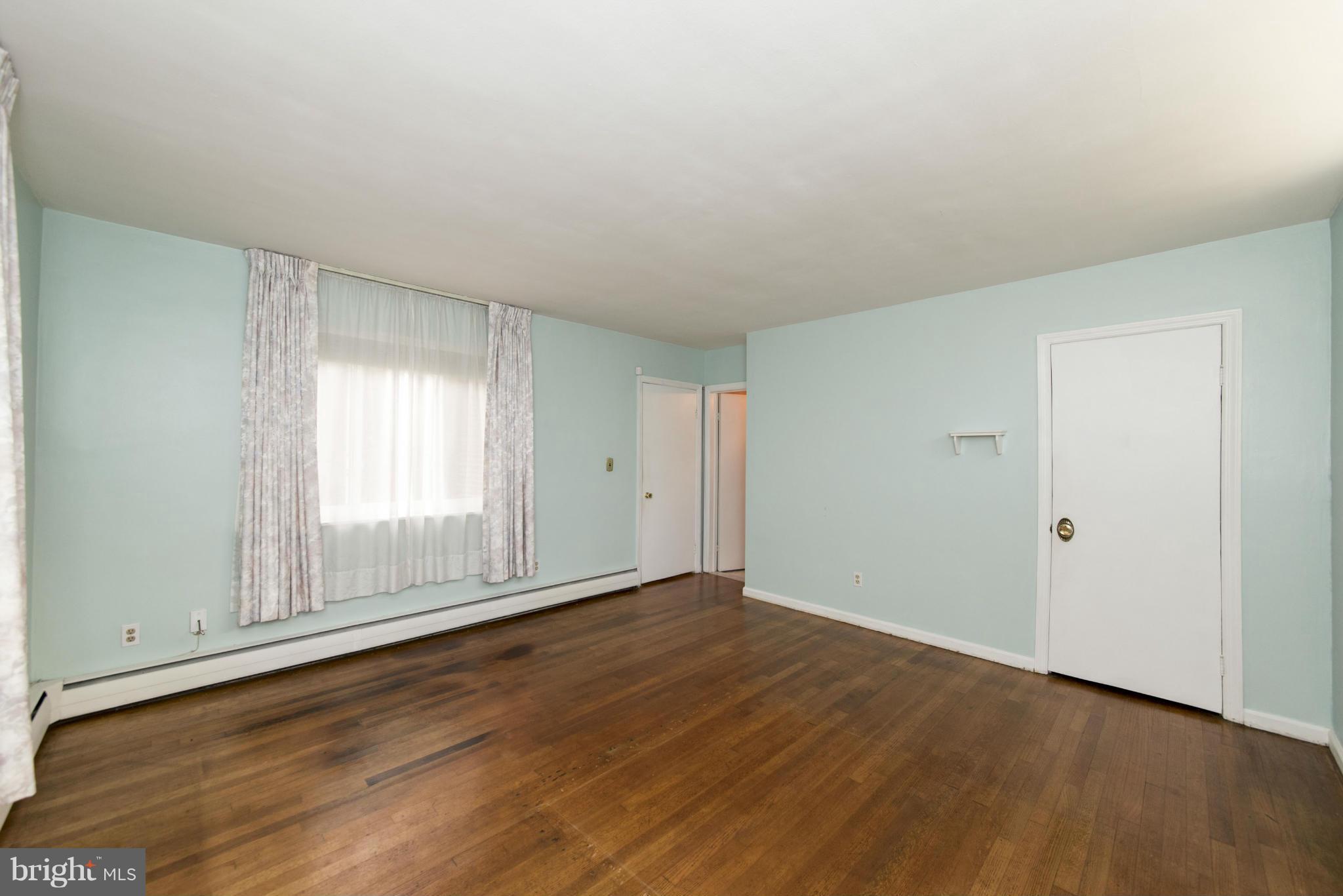 1107 Litchfield Road Baltimore, MD 21239 - Photo 14 of 30 a view of an empty room with wooden floor and a window