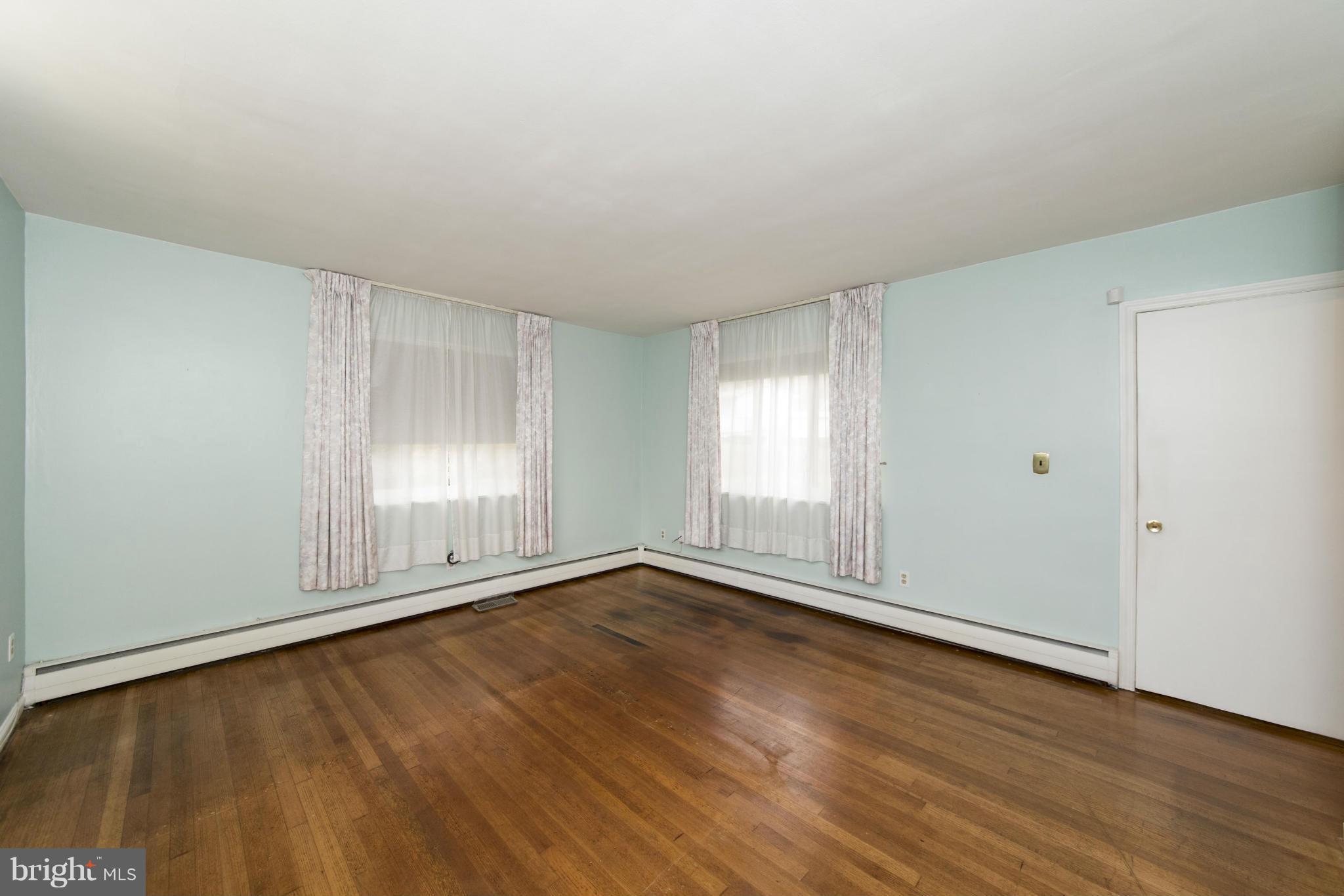 1107 Litchfield Road Baltimore, MD 21239 - Photo 15 of 30 an empty room with wooden floor and windows