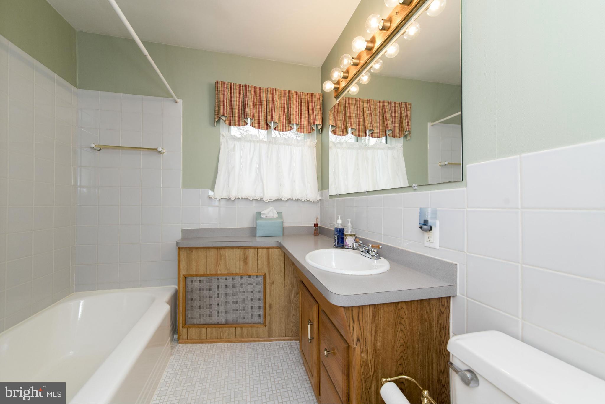 1107 Litchfield Road Baltimore, MD 21239 - Photo 20 of 30 a bathroom with a sink a toilet and bathtub