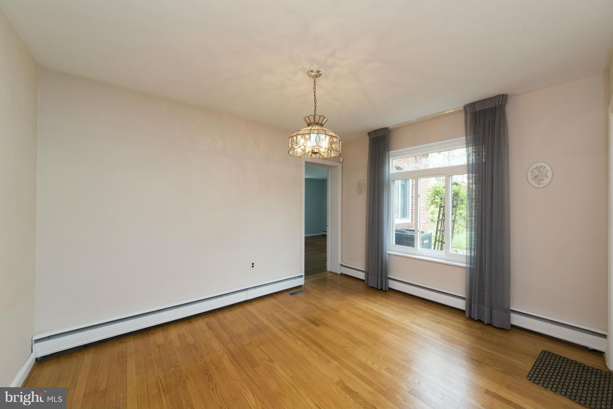 1107 Litchfield Road Baltimore, MD 21239 - Photo 6 of 30 an empty room with wooden floor and windows
