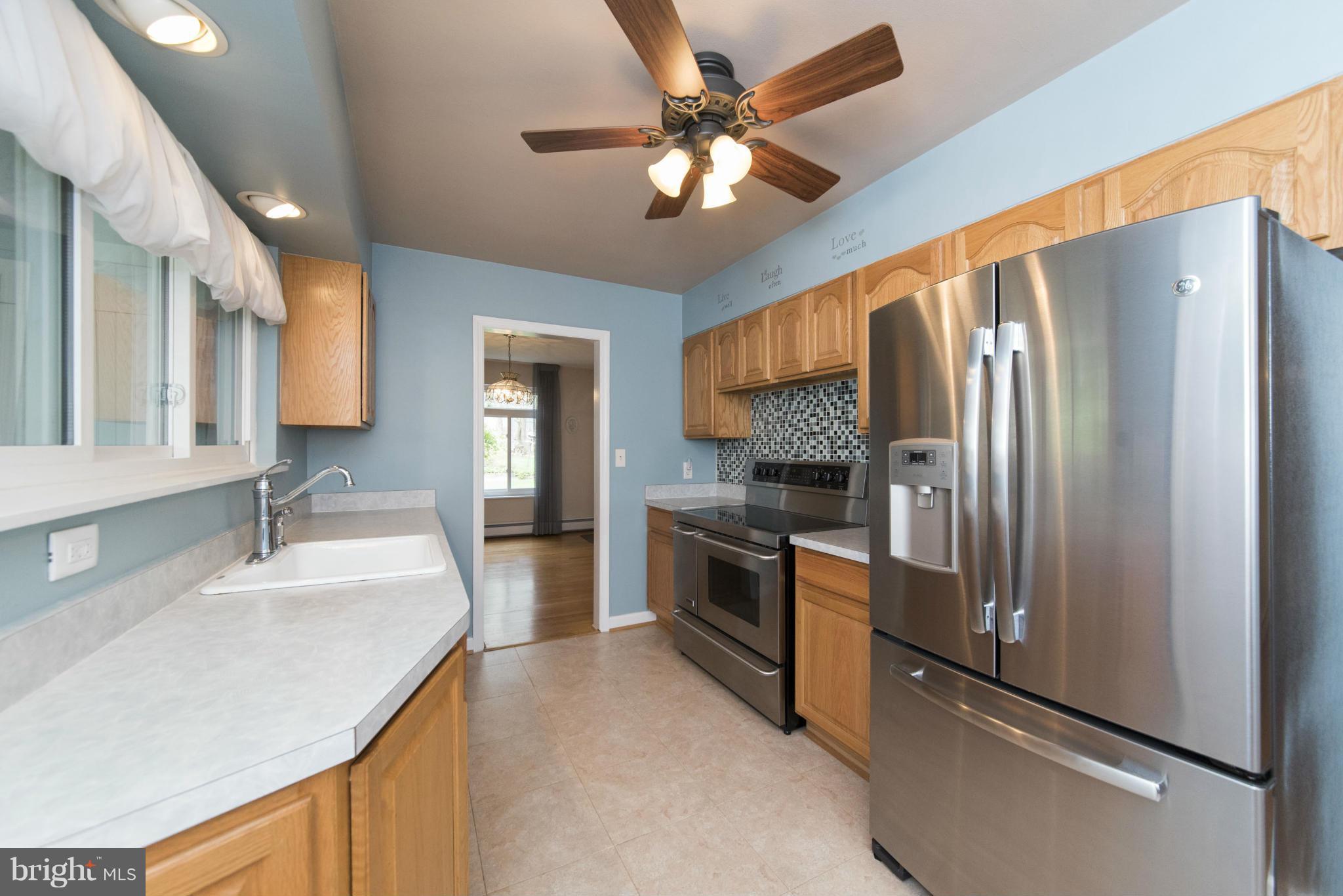 1107 Litchfield Road Baltimore, MD 21239 - Photo 8 of 30 a kitchen with stainless steel appliances granite countertop a refrigerator a sink a stove and island