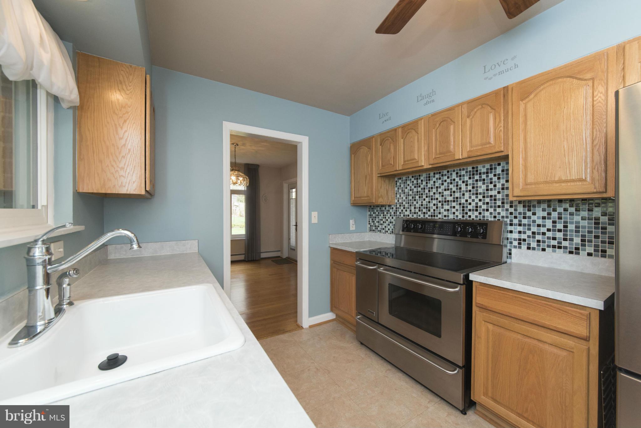 1107 Litchfield Road Baltimore, MD 21239 - Photo 10 of 30 a kitchen with a sink stove and cabinets