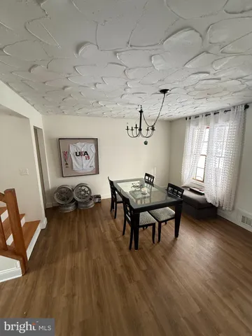 a view of a livingroom with wooden floor and stairs