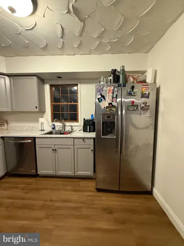 a kitchen with sink a microwave and cabinets
