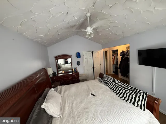 a bedroom with a bed and a night stand