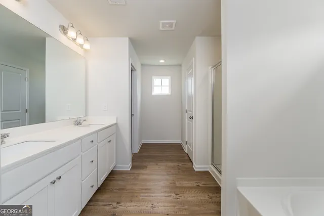 a bathroom with a double vanity sink mirror and