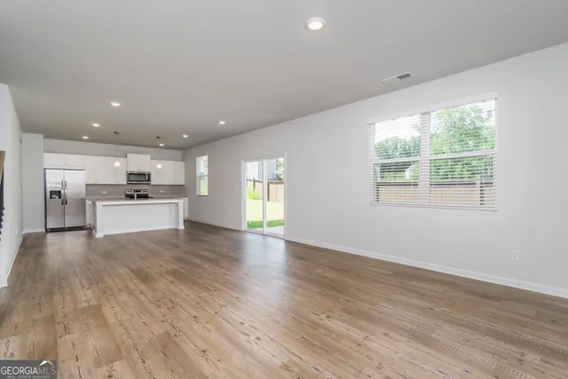 a view of a hallway with wooden floor