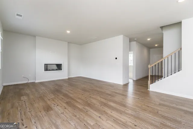a view of kitchen with wooden floor and electronic appliances