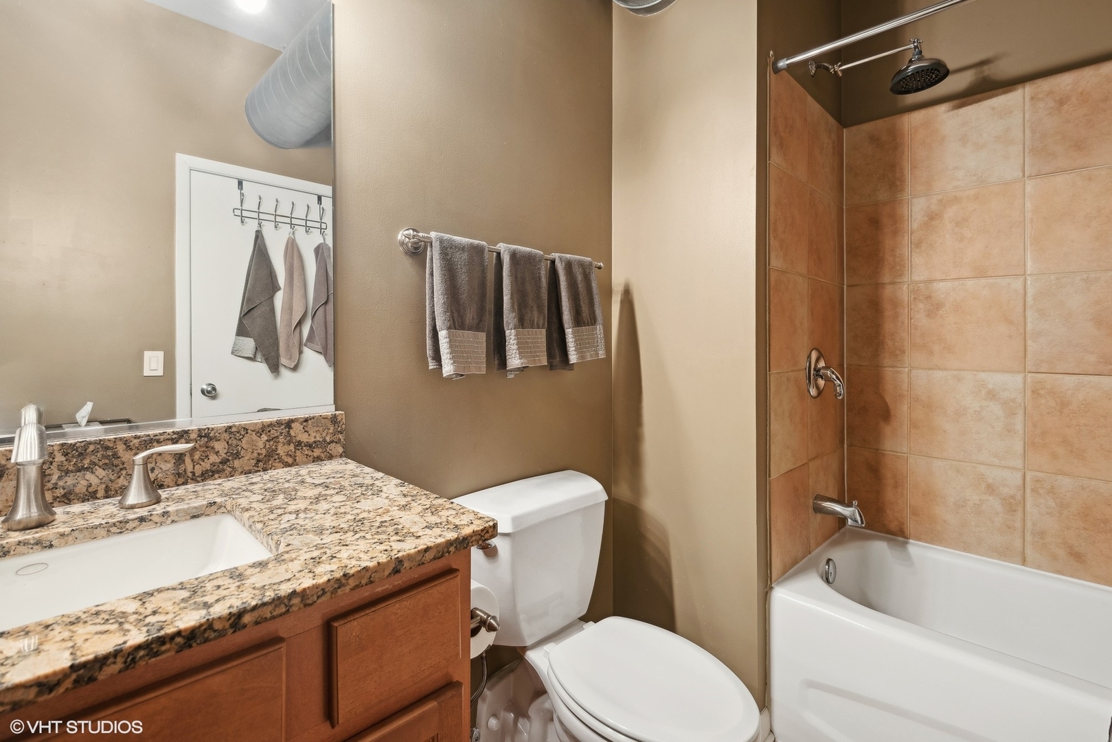 1200 West Monroe Street, Unit 619 Chicago, IL 60607 - Photo 11 of 16 a bathroom with a granite countertop sink toilet and shower