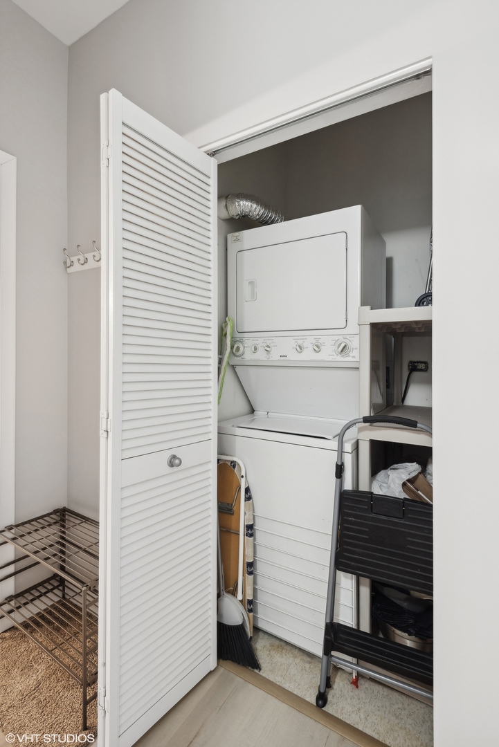 1200 West Monroe Street, Unit 619 Chicago, IL 60607 - Photo 12 of 16 a view of a kitchen with refrigerator and white cabinets