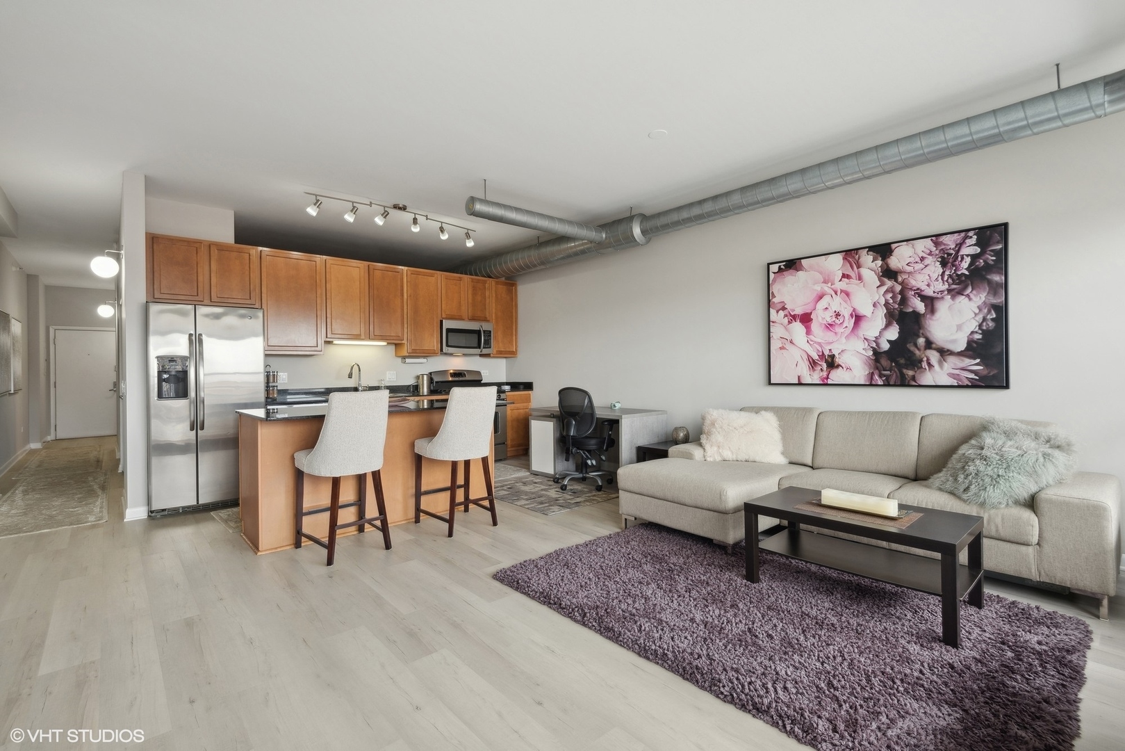 1200 West Monroe Street, Unit 619 Chicago, IL 60607 - Photo 5 of 16 a living room with lots of furniture and kitchen view
