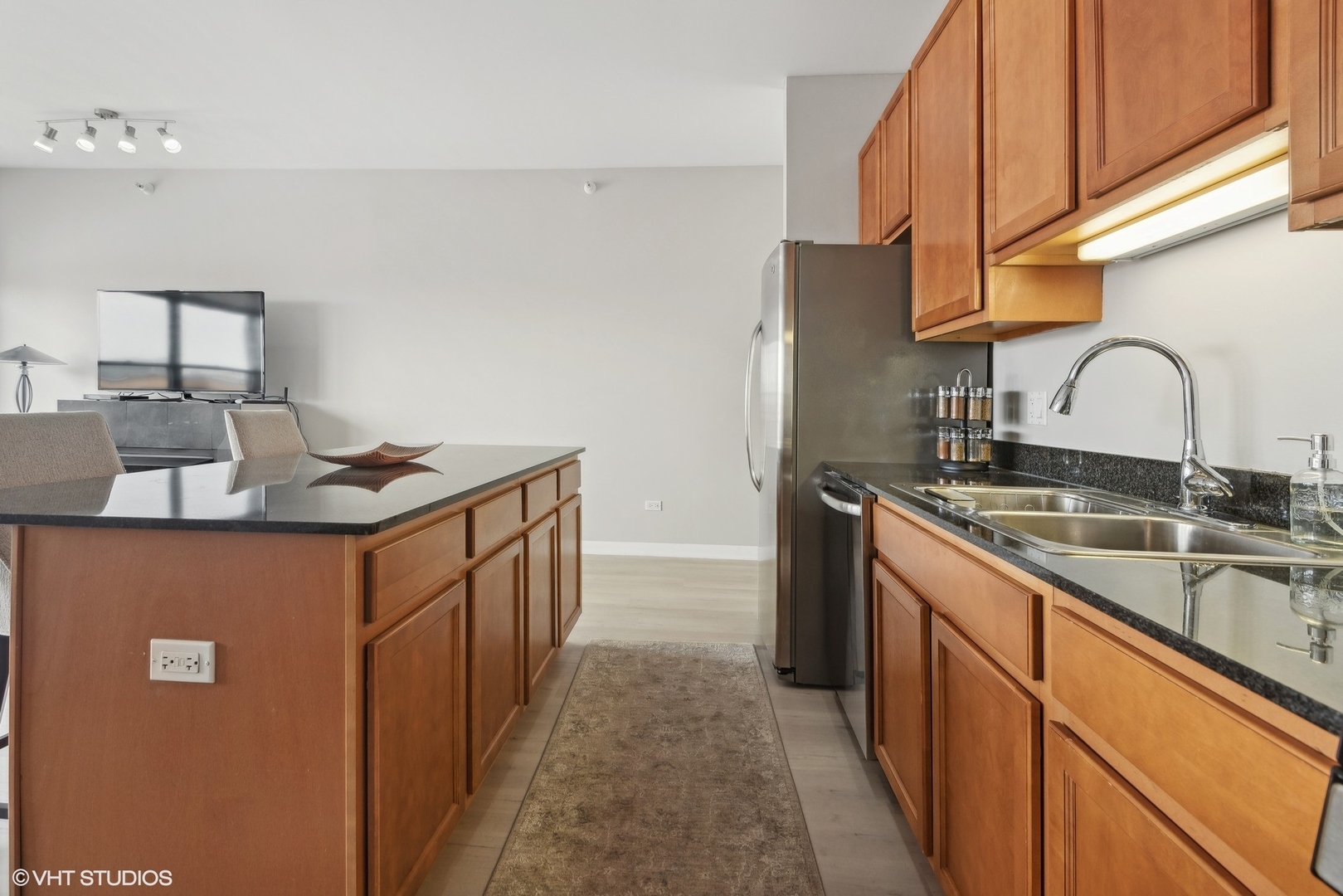 1200 West Monroe Street, Unit 619 Chicago, IL 60607 - Photo 7 of 16 a kitchen with stainless steel appliances granite countertop a sink stove and cabinets